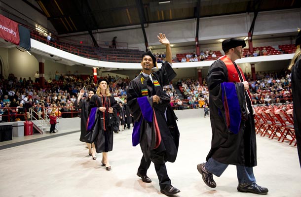 Graduates waved to the crowd as they process in to the School of Law Commencement.