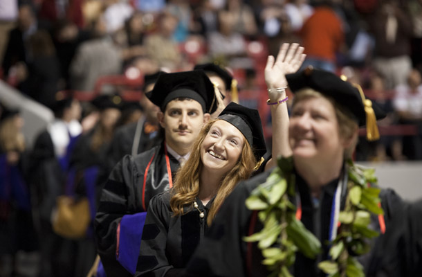 Graduates waved to the crowd as they process in to the School of Law Commencement.