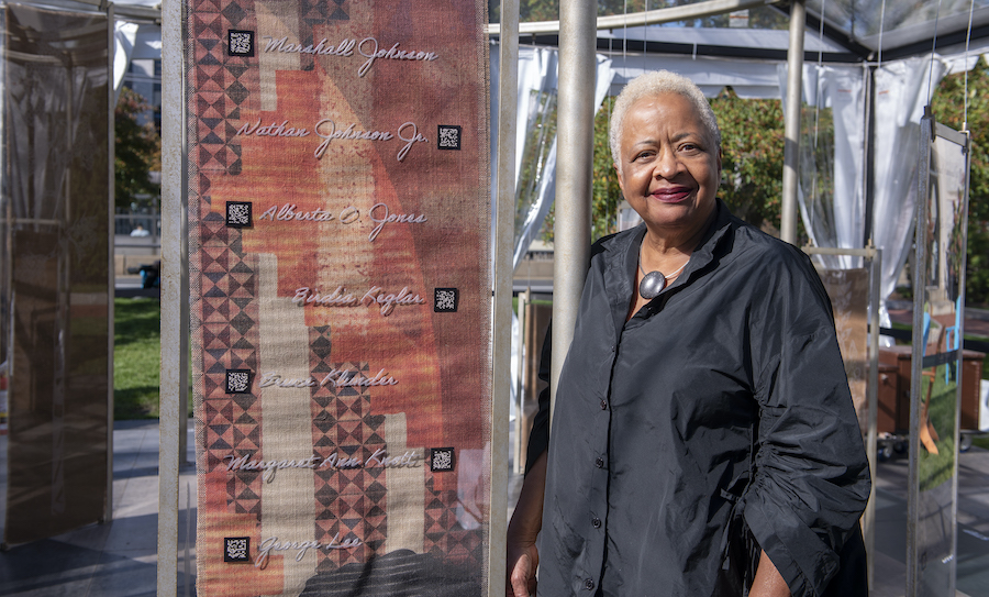 Professor Margaret Burnham visits the “Un(re)solved” installation. The augmented reality art installation is designed as a “memory forest” that weaves together history and present day stories of those who have been lost, as told by their descendants.