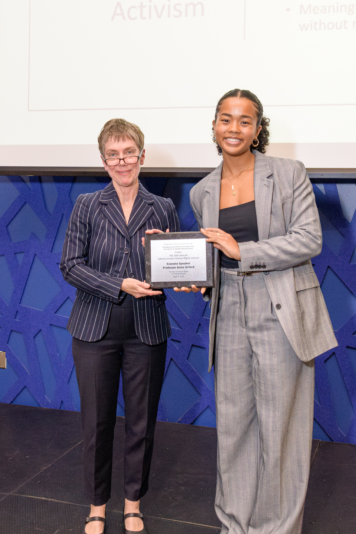 Sydney Palmer ’26 (left) presents keynote speaker Anne Orford with a gift on behalf of BLSA.